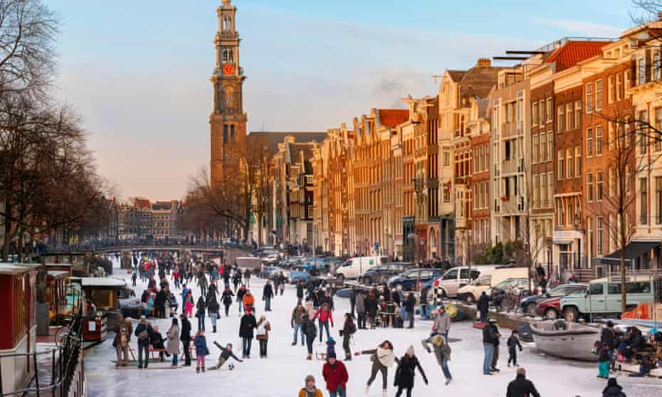 Amsterdam Ice Skating on a frozen Canal in winter.