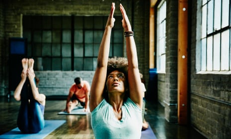 Woman warming up for yoga class in studio