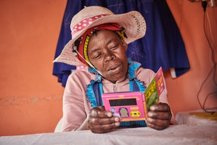 Nteboheng Molefe from Ramafolo village listens to the Xhosa version of the talking book, while following the illustrations and text.