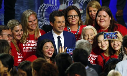 Democratic presidential candidate Pete Buttigieg poses with an advocacy group after the debate