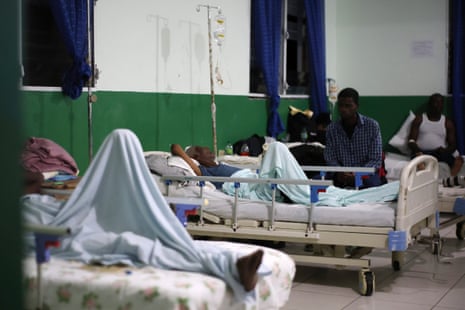 People receive medical attention at a hospital for injuries from flooding of the La Digue River in Petit-Goâve, Haiti.