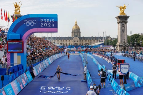 Cassandre Beaugrand of France wins the women’s triathlon race at Pont Alexandre III.