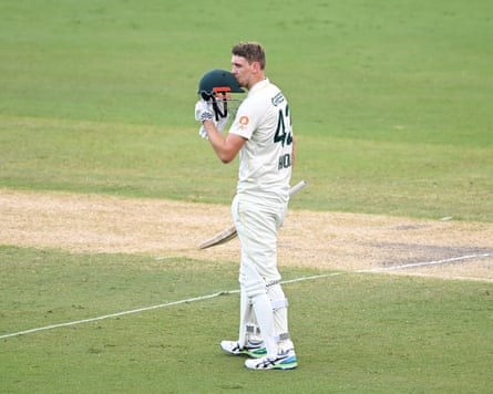 Cameron Green kisses his helmet after reaching his century.