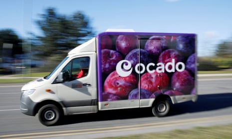 An Ocado delivery van seen driving along a road