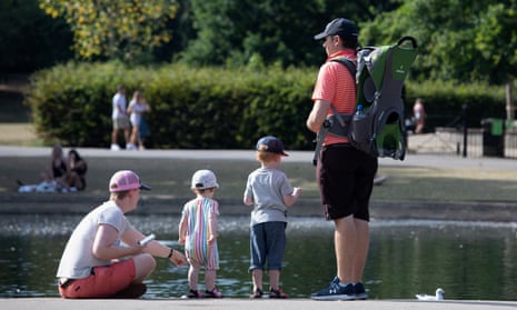 A family relaxes by a pond in Regent’s Park, London, in August.