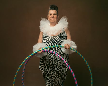 Sarah with clowns ruff holding hoola hoops.