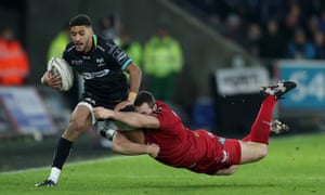 Keelan Giles is tackled by Ken Owens during Ospreys’ Pro12 match against Scarlets.
