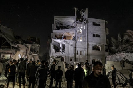 Search and rescue operations for the people in a building that has been attacked by Israeli forces in Deir al-Balah, Gaza.