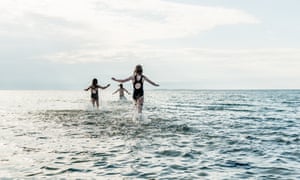 Danish children bathing in the ocean on the island of Samsø in Denmark.