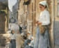 Painting: A Street in Brittany by Stanhope Alexander Forbes. The painting shows young women dressed in blue skirts and white shirts knitting and making nets in the street. Many in the background are sitting while one woman in the foreground is standing.