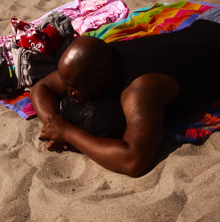 A beachgoer sunbathing in Santa Monica.