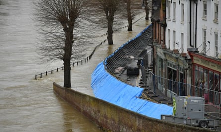 Temporary flood barriers hold back the river Severn in Ironbridge, Shropshire