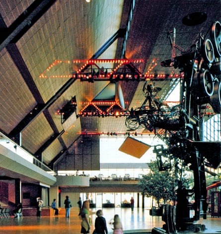 interior of mall with lit-up, bridge-like structure along ceiling