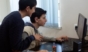 Rafael Sahakyan shows a friend the secrets of coding.