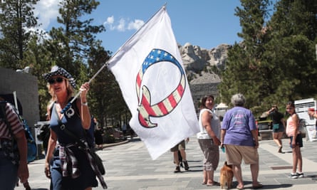 A Donald Trump supporter holding a QAnon flag in Keystone, South Dakota