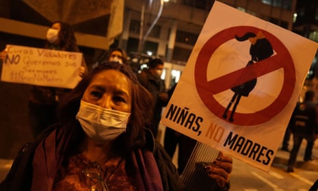 A woman holds a banner that reads ‘Girls not mothers’ during an abortion rights demonstration in La Paz, Bolivia.
