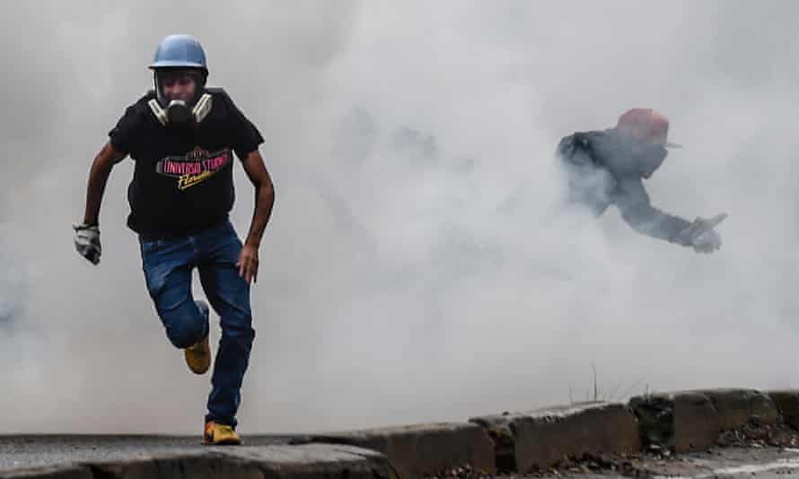 Opposition demonstrators clash with riot police during an anti-government protest in Caracas on 20 July 2017.
