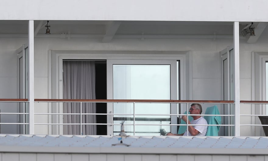 Passengers sit in quarantine aboard a cruise ship in Fremantle, Australia.