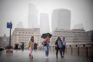 London: people cross London Bridge during a heavy rainfall as the the British Meteorological Office has warned of widespread flash floods as thunderstorms are likely across the country.