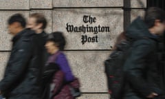 FILE - People walk by the One Franklin Square Building, home of The Washington Post newspaper, in downtown Washington on Feb. 21, 2019. The Washington Post has fired reporter Felicia Sonmez, who has triggered a vigorous online debate this past week over social media policy and public treatment of colleagues. (AP Photo/Pablo Martinez Monsivais, File)