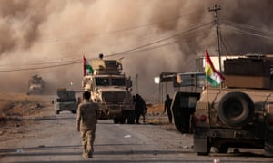 Smoke rises during clashes between Peshmerga forces and Islamic State militants in the town of Bashiqa, east of Mosul.