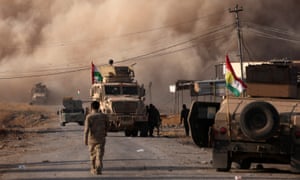 Smoke rises during clashes between Peshmerga forces and Islamic State militants in the town of Bashiqa, east of Mosul. 