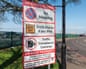 An airport road sign warning motorists if they stop in a restricted red zone they'll be fined £100.