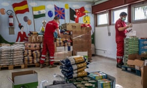 Italian Red Cross volunteers prepare food for distribution to people with financial difficulties in Catania.