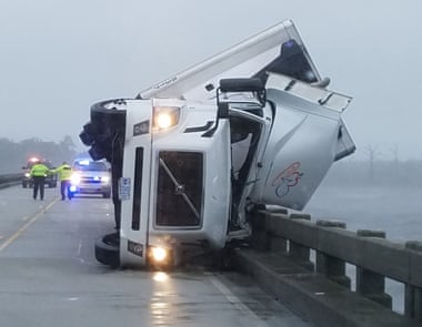 High winds tipped over this18-wheeler, killing its driver and shutting down the US64 bridge in North Carolina.