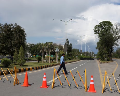 A police officer walks on the road, blocked for security measures, leading to the Serena Hotel.