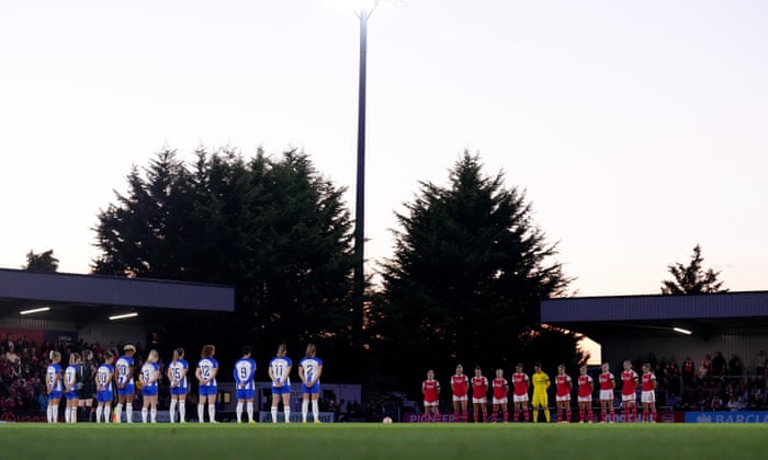Both teams line up for a minute’s silence in honour of The Queen before kick off.