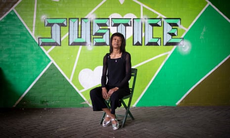 Jacqui Haynes in front of a sign saying 'justice'