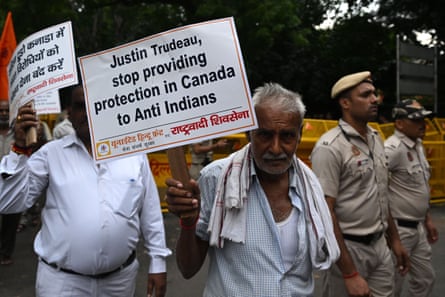 A member of United Hindu Front organisation looks on while holding a banner condemning Canada’s prime minister Justin Trudeau.