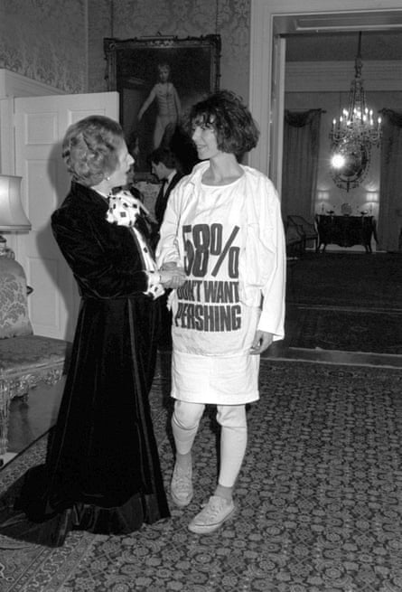 Margaret Thatcher greets Katharine Hamnett, who is wearing a T-shirt with a nuclear missile protest message, at a Downing Street reception the prime minister hosted for London fashion week designers in 1984.