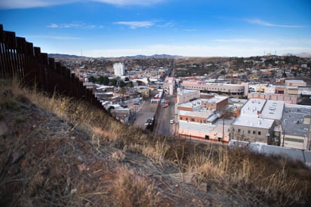 A border fence stretching through Nogales in Arizona and Nogales in Mexico. The image is part of a photo project documenting life on both sides of the US-Mexico border
