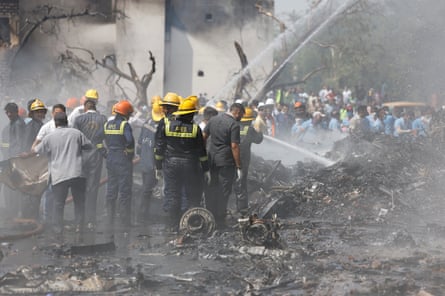 Firefighters spray water at the site