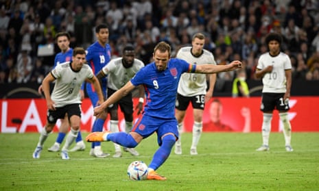 England’s forward Harry Kane shoots from the penalty spot to score his team’s equaliser.