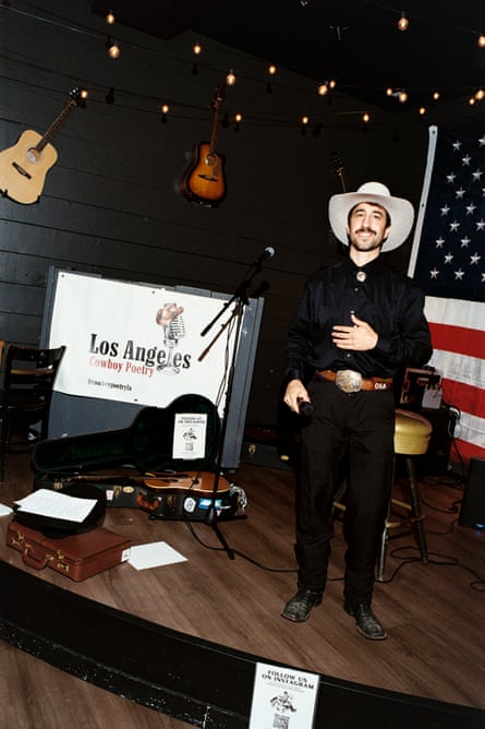 A man in a cowboy hat stands for a potrait