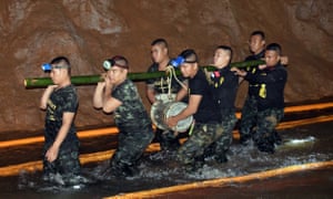 Thai soldiers carry pumping equipment inside the flooded cave complex.
