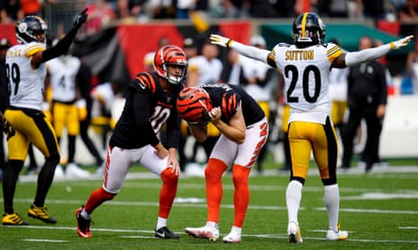 Evan McPherson (centre) reacts after missing a field goal during overtime against the Pittsburgh Steelers.