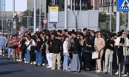 People gather outside the Central station amid safety checks on the railway network, in Naples, Italy, on 27 September.