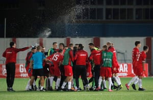 The Gibraltar players celebrate at the end of the match.