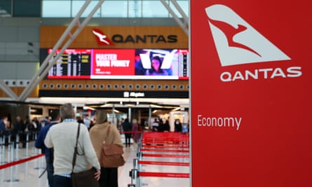 People arrive at the Qantas domestic terminal at Sydney Airport.