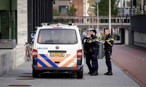 Police outside  court in Amsterdam during the first session in the case against the suspects of the murder of Peter R de Vries
