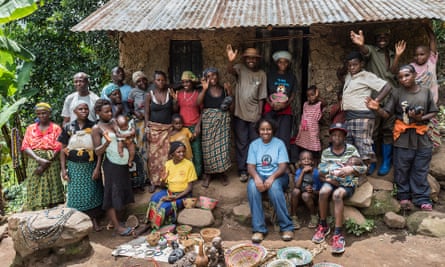 ‘Now locals get a share of the tourist dollar, they help protect the gorillas’: Dr Gladys and staff with some of the members of the Batwa pygmy community in Bwindi.