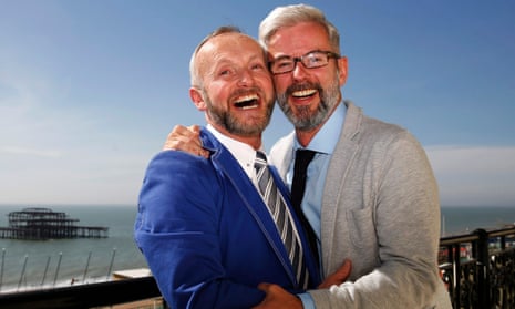 Andrew Wale (right) and Neil Allard laugh as they pose after marrying in Brighton in one of the first same-sex weddings in March 2014. 