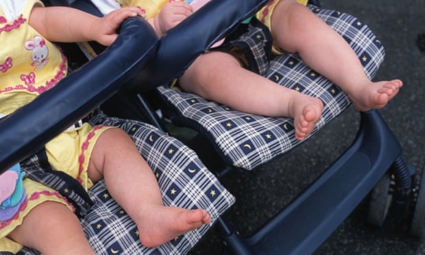 Feet of two babies in stroller