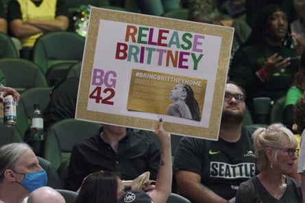 A fan at a WNBA playoff basketball game between the Seattle Storm and the Washington Mystics holds up a sign supporting Brittney Griner.