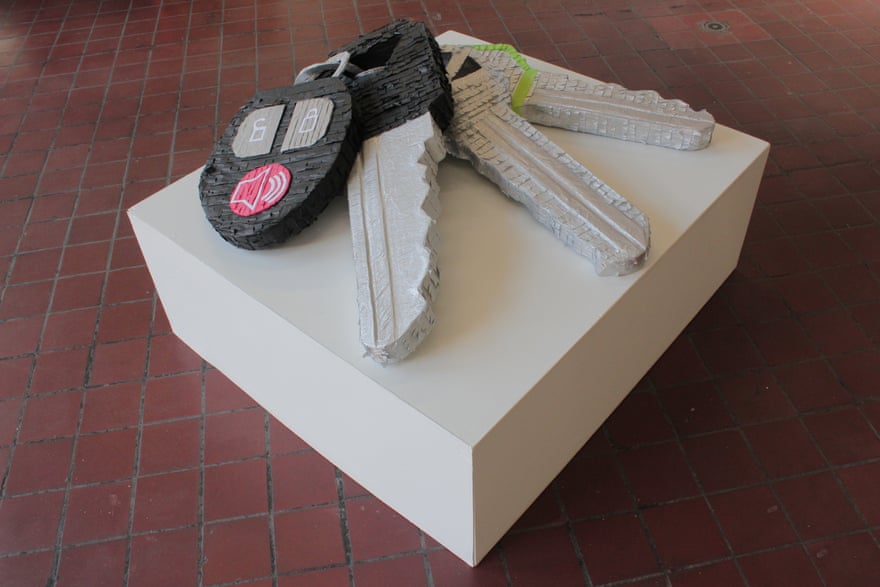 A white square base holds an enlarged set of car keys done in piñata.