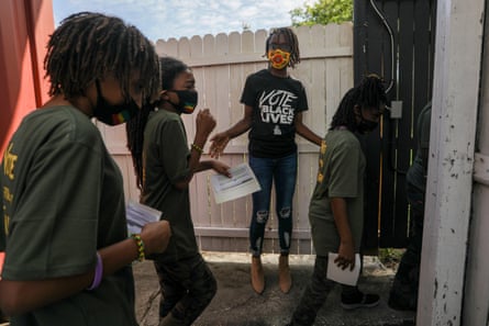 Mitha Charlot, center, directs students from LinaBean Academy to the stage during Souls to the Polls, an effort to mobilize Black voters in Hillsborough county.